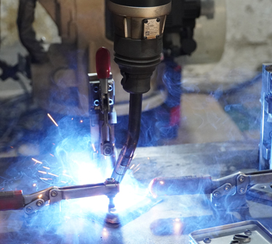 Laser welding process with blue sparks, showcasing DELTA CAINA's advanced technology and precision manufacturing for high-quality furniture hardware production.